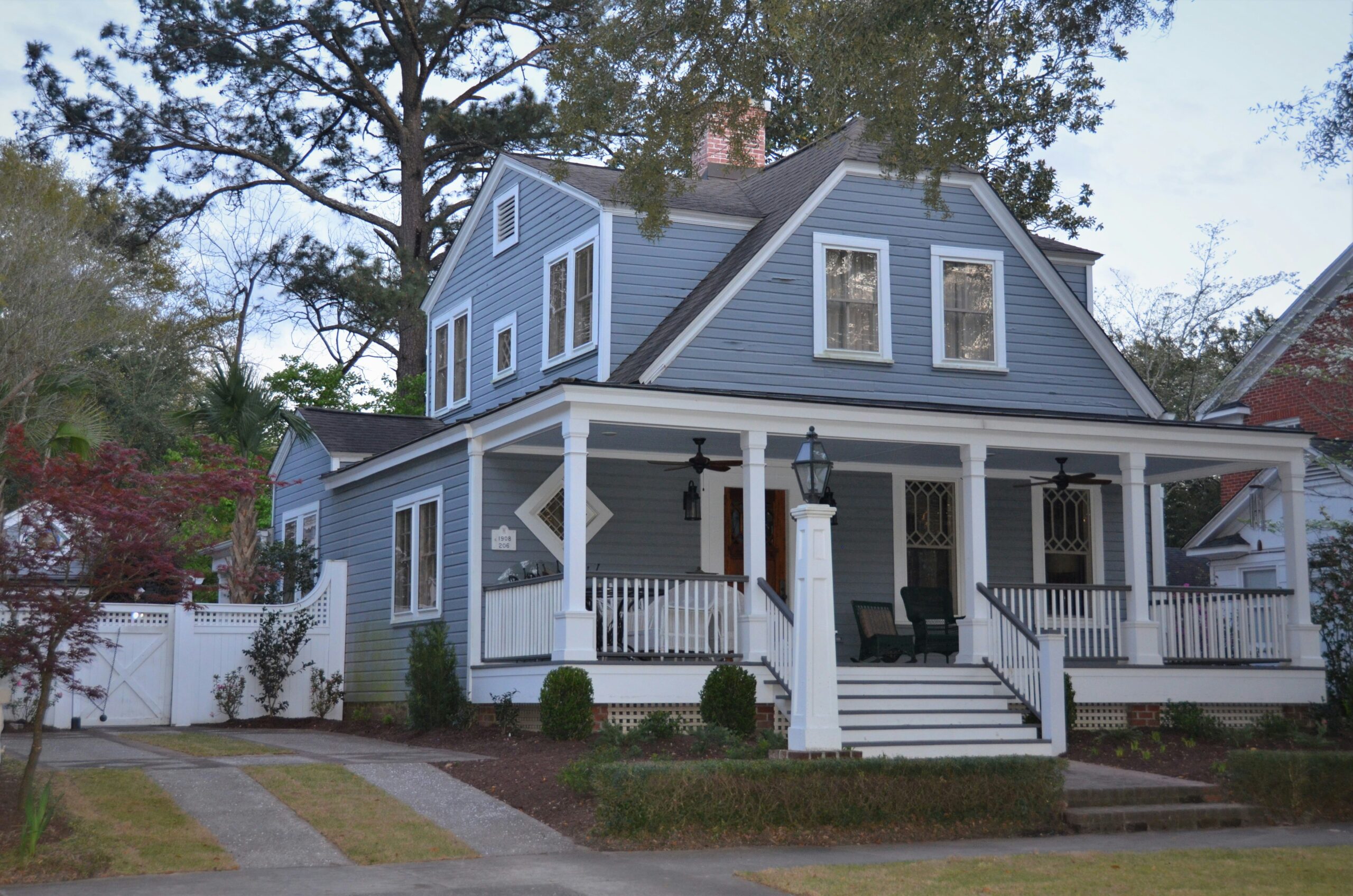 Blue two-story Colonial Revival home with a front porch in New Haven, Indiana